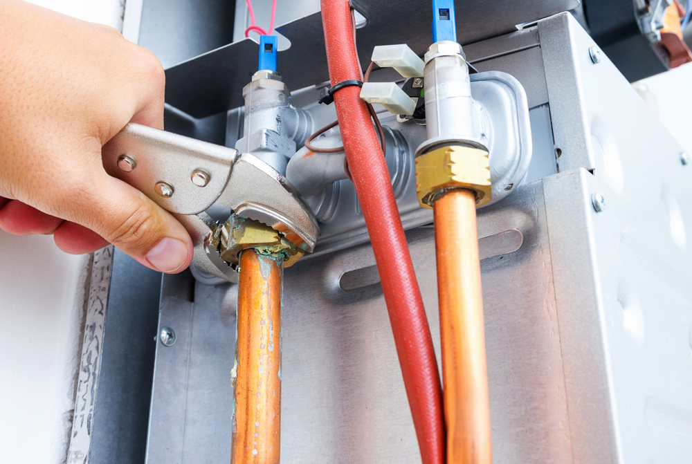Plumber,Repairing,A,Gas,Boiler,Of,A,Heating,Home,System